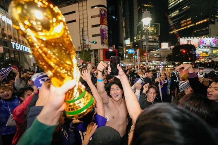 지난 24일 일본 축구팬들이 도쿄 시부야 거리에서 2022 카타르 월드컵 일본 축구 대표팀이 독일을 상대로 승리한 것을 축하하고 있다. [이미지출처=AP연합뉴스]