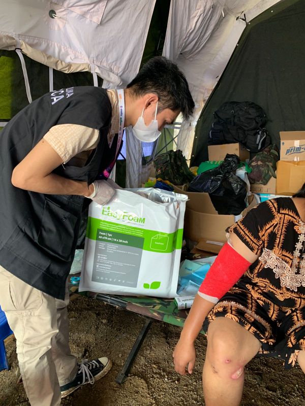 인도네시아 WOCARE 소속 간호사가 치안주르 지진으로 인해 발생한 부상자에게 '이지폼'을 사용하기 위해 제품을 개봉하고 있다.[사진=시지바이오 제공]