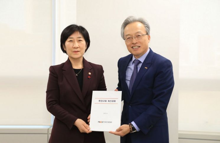 최진식 한국중견기업연합회 회장(오른쪽)이 한화진 환경부 장관에게 '환경 규제 개선 과제'를 전달하고 있다.