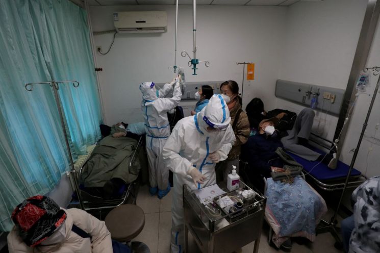 27일 중국 베이징의 중일우호병원 발열 진료소에서 방역복을 입은 의료진들이 환자를 돌보고 있다.사진=로이터·연합뉴스