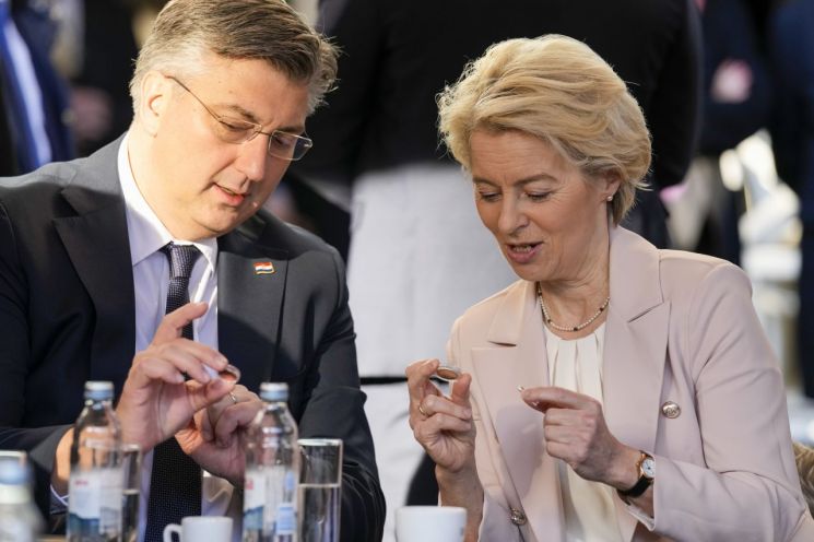 1일(현지시간) 자그레브에서 회담을 가진 플렌코비치 크로아티아 총리(왼쪽)와 우르줄라 폰데어라이엔 유럽연합(EU) 집행위원장이 유로 동전을 함께 살펴보고 있다.자그레브= AP·연합뉴스