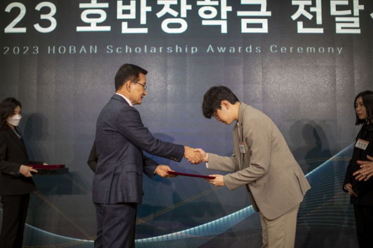 김상열 호반장학재단 이사장(왼쪽)이 '2023 호반장학금 전달식'에서 장학증서를 수여하고 있다.