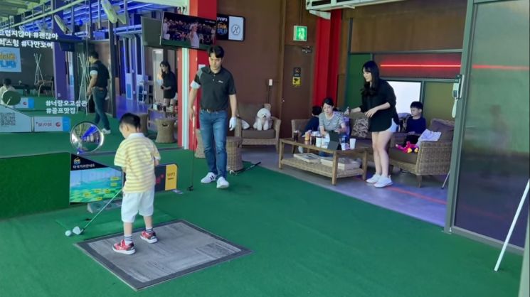 쇼골프 김포공항점에 마련된 패밀리석에서 자녀를 동반한 가족 이용객들이 연습을 하고 있다.[사진제공=XGOLF]