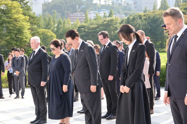 윤석열 대통령과 김건희 여사가 27일 부산 남구 유엔기념공원 방문, 유엔 참전국 정부대표단과 함께  유엔군 위령탑에 헌화한 뒤 묵념하고 있다. [이미지출처=연합뉴스]