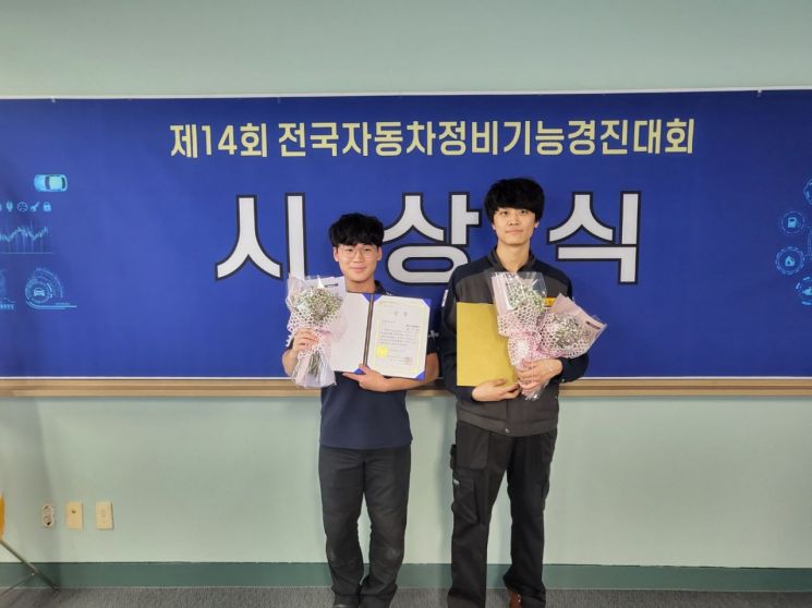 차체 수리 분야에서 은상을 받은 권우성 학생(왼쪽), 자동차 정비 분야에서 장려상을 받은 김정우 학생이 수상 기념사진을 찍고 있다.