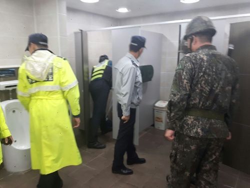 폭발물 테러 예고에 사직야구장 화장실을 수색하고 있는 경찰과 군인. [사진=부산 동래경찰서]