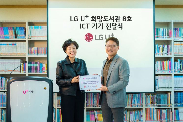 (오른쪽부터)LG유플러스 이철훈 대외전략그룹장(전무)과 광주세광학교 김선미 교장이 광주세광학교에서 진행한 U+희망도서관 8호점 지원 기금 및 현판 전달식에서 기념촬영을 하고 있다.[사진제공=LG유플러스]