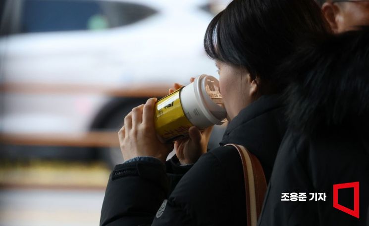 서울 중구 소공동에서 출근길에 나선 직장인이 따뜻한 커피를 마시고 있다. 사진=조용준 기자 jun21@
