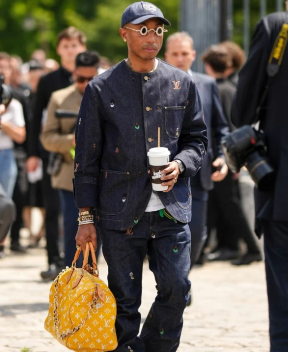 Louis Vuitton's Creative Director Pharrell Williams is holding a 'Millionaire Speedy'. <br>[Image source=SCMP]
