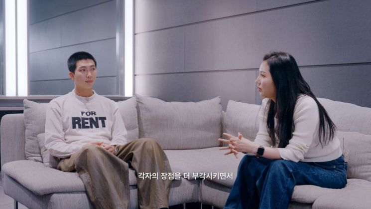 BTS RM and Shin Seonjeong, General Manager, discussing the T&D system<br>[Photo by HYBE]