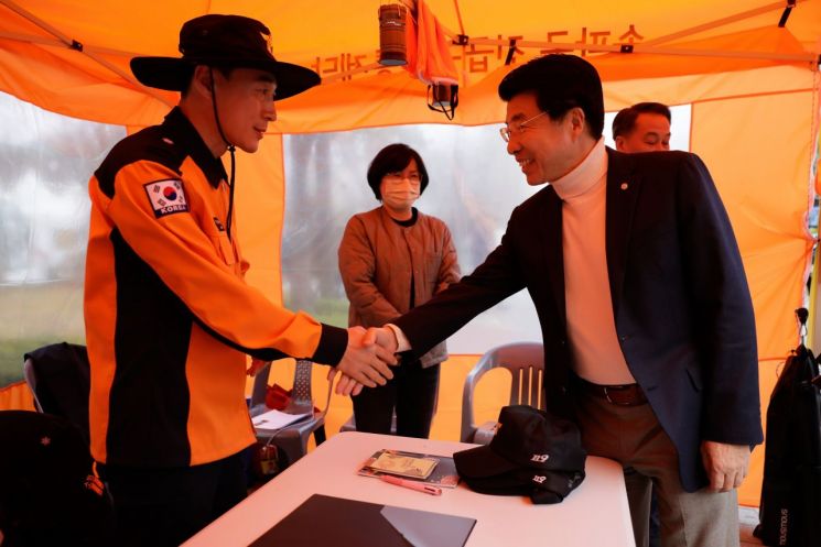 Seok-Suk Seo, Mayor of Songpa District (right), is encouraging a safety officer.