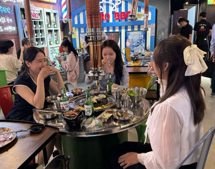 베트남 하노이에 살고 있는 대학생 부 띠 땀 씨가 친구들과 한국식당에서 과일소주를 즐기고 있다.[사진=하노이 공동취재단]