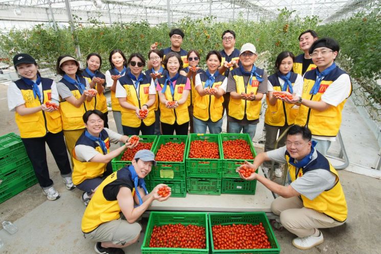 한국맥도날드 본사 임직원들이 24일 '푸르메소셜팜'에서 농산물을 선별해 다듬고 가공·포장하는 봉사활동을 진행한 뒤 기념촬영하고 있다.[사진제공=한국맥도날드]