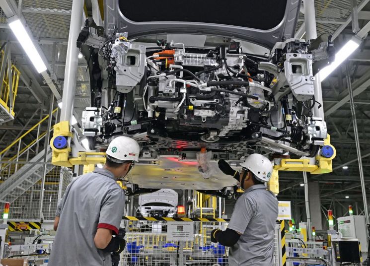 현대차 인도네시아 공장(HMMI)에서 직원들이 시범 생산중인 신형 코나 일렉트릭 차체 하부에 배터리를 체결하고 있다.[사진제공:현대차그룹]