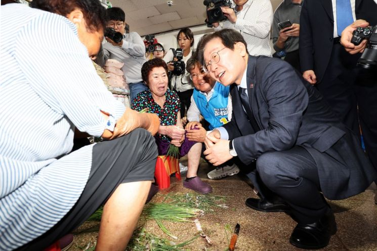 23일 낮 전남 영광군 영광터미널시장에서 이재명 더불어민주당 대표가 상인들과 인사를 나누고 있다 [이미지출처=연합뉴스]