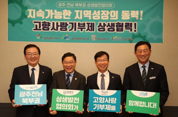 광주·전남 북부권 상생발전협의회 제8차 정례회의에 참석한 문인 광주 북구청장, 정광선 담양 부군수, 박병규 광주 광산구청장, 김한종 장성군수(사진 왼쪽부터)가 고향사랑기부제 활성화를 위한 손팻말 퍼포먼스를 하고 있다. 광주 북구 제공