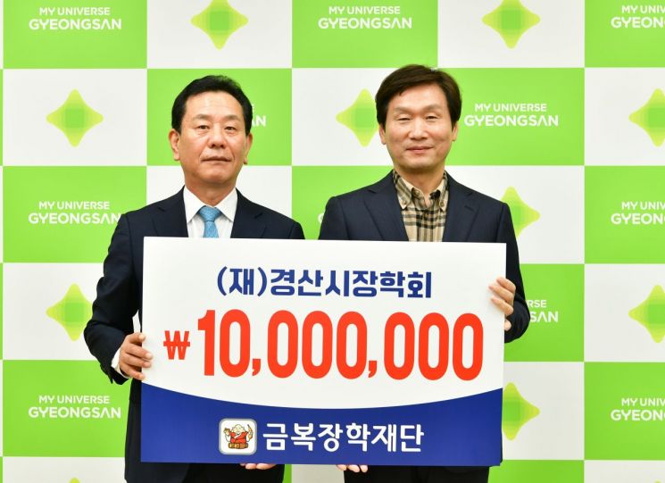 김일환 금복주 대표(왼쪽)가 장학금 1000만원을 기탁한 뒤 조현일 경산시장과 기념촬영을 하고 있다.