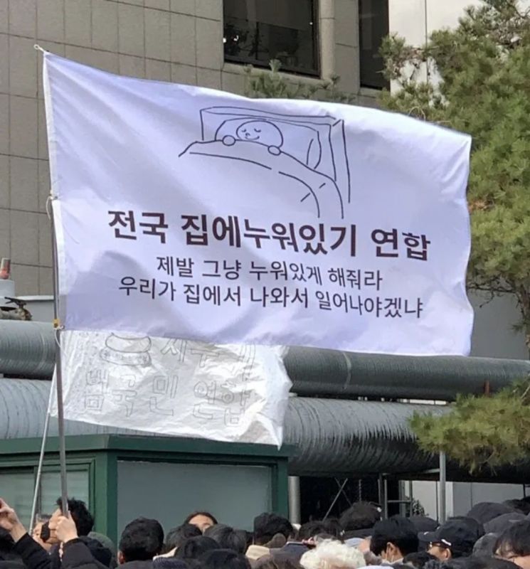 7일 서울 여의도 국회 앞 집회 현장에 등장한 '전국 집에누워있기 연합' 깃발. 온라인 커뮤니티 더쿠