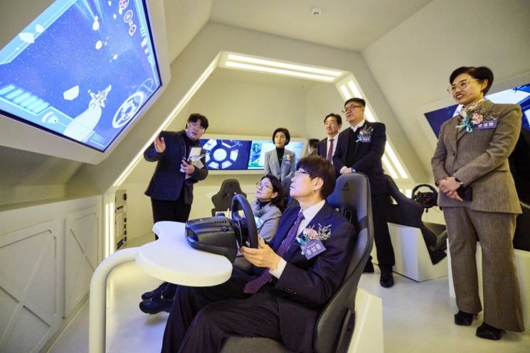 새싹누리관에서 개관식 참석자들이 우주선을 조종하는 체험을 하고 있다.
