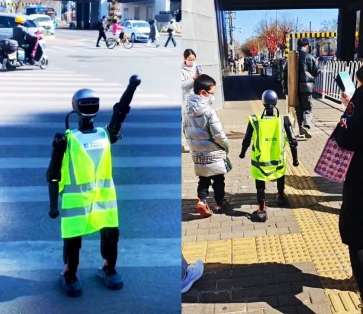 "사람같다" 구경꾼 몰려 교통마비…베이징에 등장한 교통안내 로봇