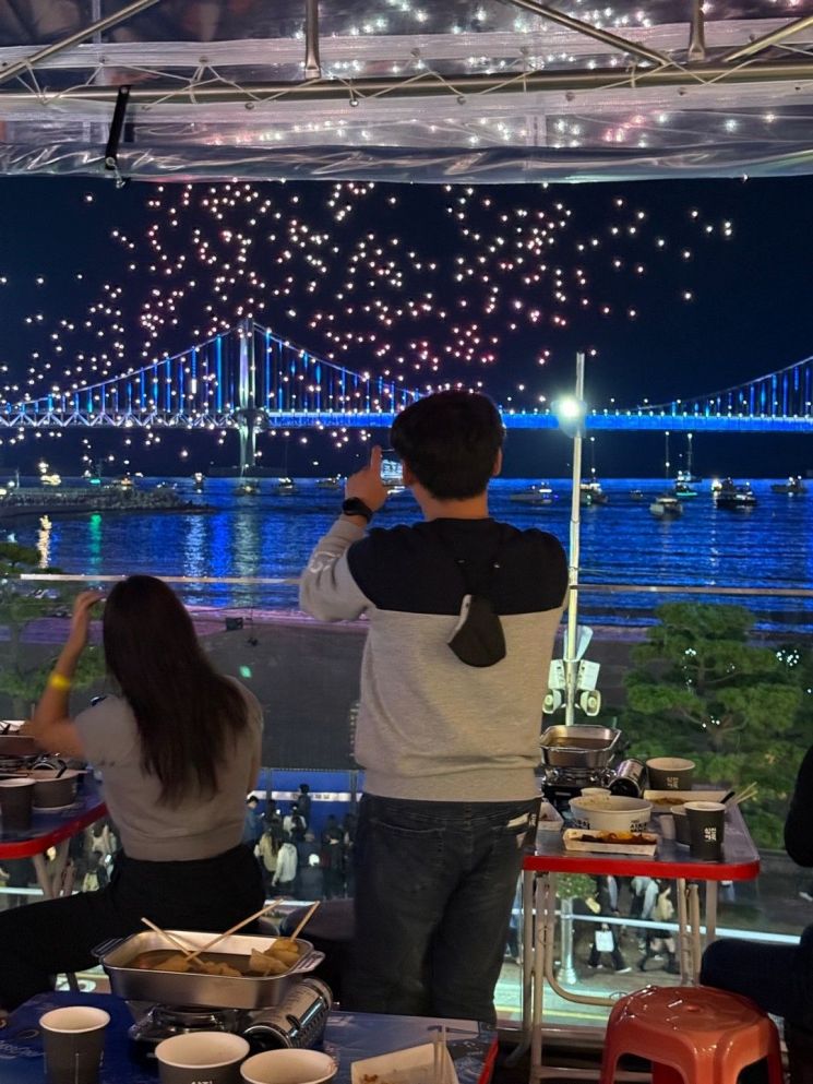 삼진포차 방문객이 드론쇼를 즐기고 있다.
