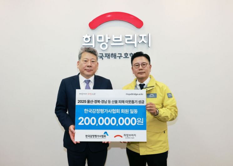 왼쪽부터 양길수 한국감정평가사협회 회장과 신훈 희망브리지 사무총장이 성금 기탁식 진행 후 기념촬영을 하고 있다. 희망브리지