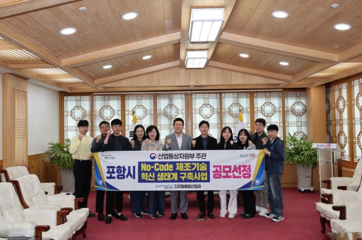 포항시가 산업통상자원부가 주관한 ‘노코드(No-Code) 제조기술 혁신 생태계 구축사업’ 공모에 선정돼 관련부서 직원들과 이강덕 시장이 기념촬영하고 있다. 포항시 제공