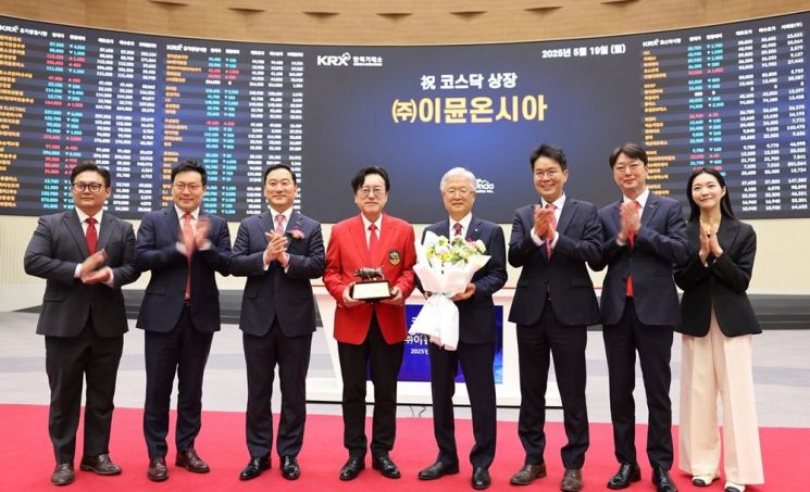 빨간색 자켓을 입고있는 김흥태 이뮨온시아 대표와 조욱제 유한양행 대표이사(김흥태 대표 오른쪽)가 19일 서울 영등포구 한국거래소에서 직원들과 함께 기념사진을 촬영하고 있다. 사진제공=이뮨온시아