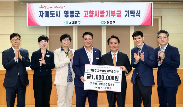 정영철 충북 영동군수(가운데)가 이성헌 서대문구청장(오른쪽 세 번째)에게 고향사랑기부금을 기탁하며 두 지자체 관계자들과 함께 기념 촬영을 하고 있다. 서대문구 제공.