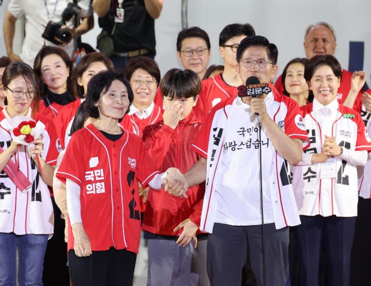 김문수 국민의힘 대선 후보가 2일 서울시청 앞 서울광장에서 열린 피날레 유세에서 부인 설난영 여사와 손을 잡고 발언하고 있다. 김 후보는 설 여사, 딸 동주씨, 사위, 손자·손녀와 함께 연단에 올랐다. 연합뉴스