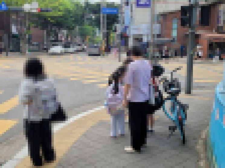 지난 9일 오전 8시30분 경기 안산시 단원구 한 초등학교 앞에서 아이들이 어른들과 함께 등교하고 있다. 공병선 기자