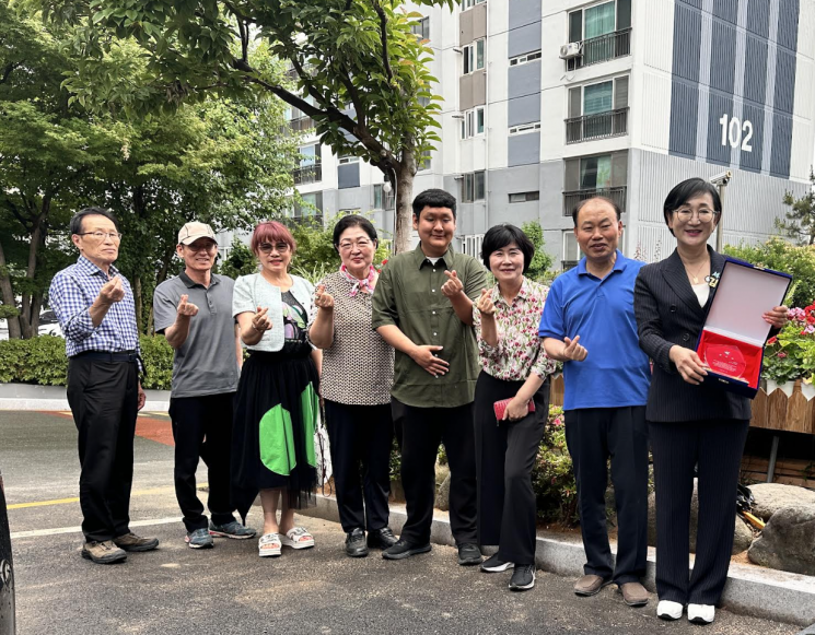 광주 서구의회 김수영 의원이 화정2동 입주자대표회의로부터 감사패를 받은 뒤 주민들과 기념촬영을 하고 있다.