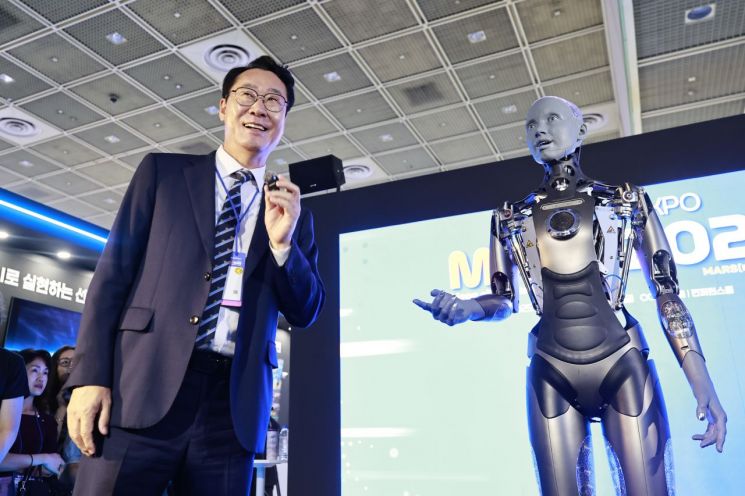 서울 삼성동 코엑스에서 18일 개막한 화성시의 AI 박람회 'MARS 2025'에서 정명근 화성시장이 휴머노이드 로봇 '아메카'와 대화하고 있다. 화성시 제공