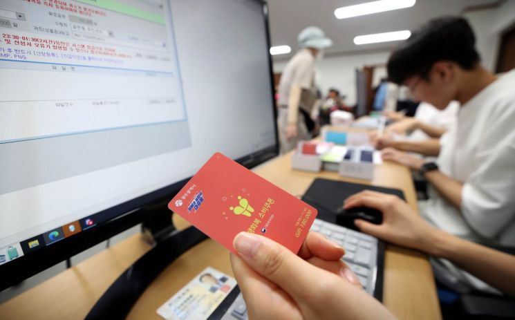 민생회복 소비쿠폰 지급 첫날인 21일 광주 북구 두암3동 행정복지센터에서 한 직원이 현물카드를 준비하고 있다. 연합뉴스