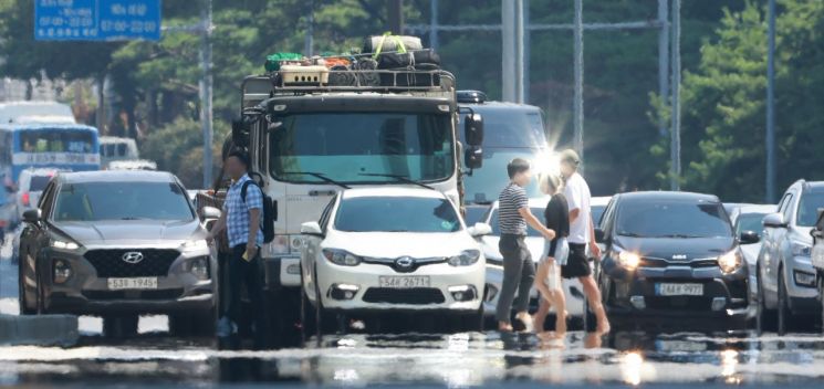 전국 대부분 지역에 폭염 특보가 발효된 25일 서울 영등포구 여의도 여의대로에 아지랑이가 피어오르고 있다. 연합뉴스