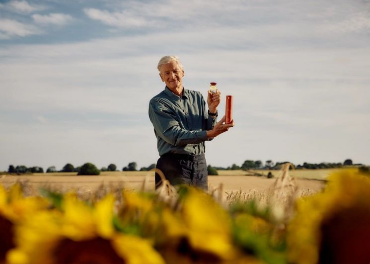 James Dyson, founder of Dyson Farming, holding the Dyson Omega Nourishing Care line