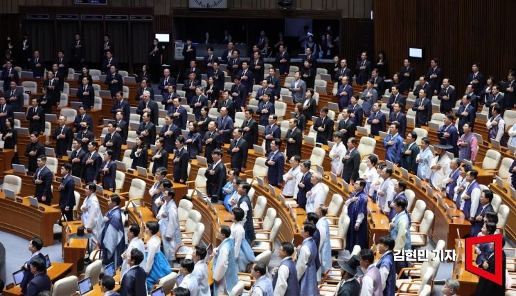 1일 국회에서 열린 정기국회 개회식에서 각각 한복과 상복을 입은 여야 의원들이 국기에 대한 경례를 하고 있다. 김현민 기자