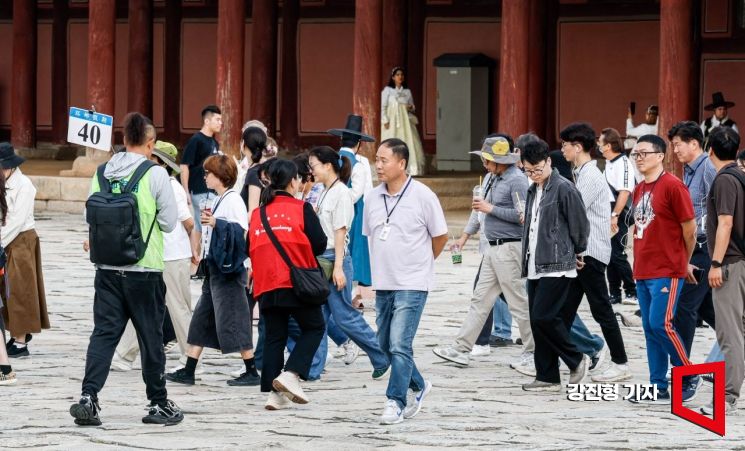 중국인 단체관광객에 대한 무비자 입국이 시행된 29일 서울 종로구 경복궁에서 중국인 단체 관광객 인솔자들이 길을 안내하고 있다. 2025.9.29 강진형 기자