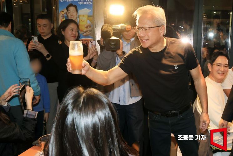 젠슨 황 엔비디아 최고경영자(CEO)가 지난 달 30일 오후 서울 강남구 삼성역 인근 깐부치킨 매장에서 이재용 삼성그룹 회장, 정의선 현대차그룹 회장과 치킨 회동 중 내부 손님들을 향해 건배하고 있다. 조용준 기자