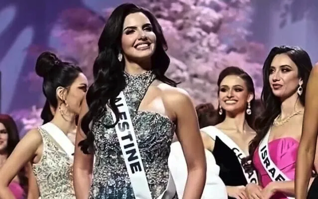 A Palestinian representative posing on the Miss Universe stage. On the right, the Israeli representative is looking in a different direction. SNS