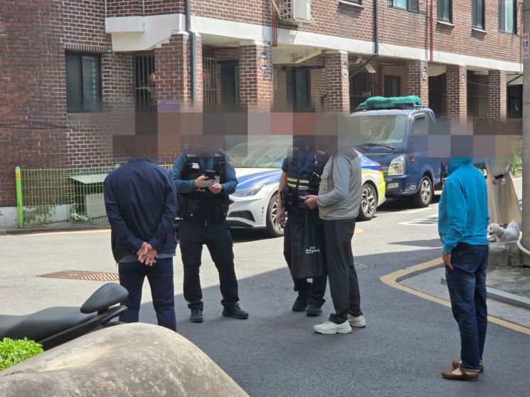 19일 오후 서울 송파구 A 공원 입구에서 경찰이 한 남성을 상대로 쓰레기봉투를 무료로 나눠주겠다고 한 경위를 확인하고 있다. 최석진 기자