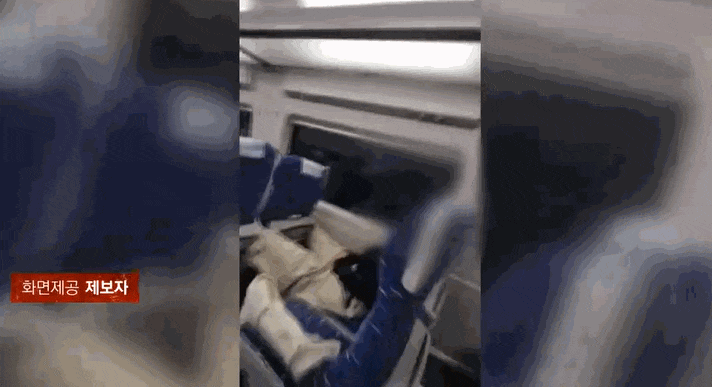 A passenger is stretching both legs out on the armrest of the front seat inside a KTX train. Captured from JTBC's <i>Sagwanbanjang</i>.