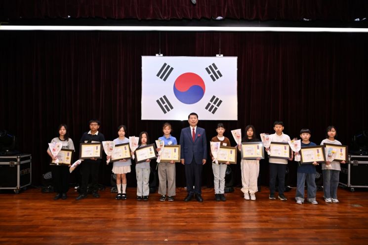On the 5th, Guri City Mayor Kyunghyun Baek, in celebration of Children's Day, awarded commendations to exemplary children and contributors to child welfare at the '2026 104th Guri City Children's Day Commemoration Event, Let's Attach Wings of Dreams and Hope,' followed by a commemorative photo. Provided by Guri City