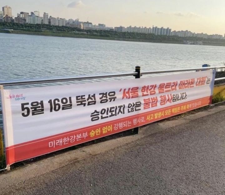 지난 15일 서울 한강공원 산책로에 ‘서울 한강 울트라 마라톤 대회는 승인되지 않은 불법 행사입니다’라는 내용의 현수막이 걸려 있다. 서울한강울트라마라톤 대회 홈페이지