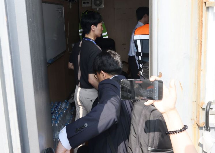 경찰 관계자들이 서소문 고가차도 붕괴사고와 관련해 29일 서울 서대문구 현장사무실을 압수수색 하며 철거 현장에 있는 컨테이너로 들어가고 있다. 연합뉴스