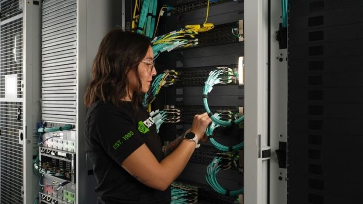 An NVIDIA engineer adjusting a server rack. NVIDIA