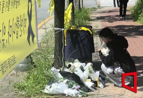지난달 7일 오전 광주 광산구 월계동 사건 현장에 한 시민이 국화꽃을 내려놓으며 희생된 여고생을 추모하고 있다. 송보현 기자