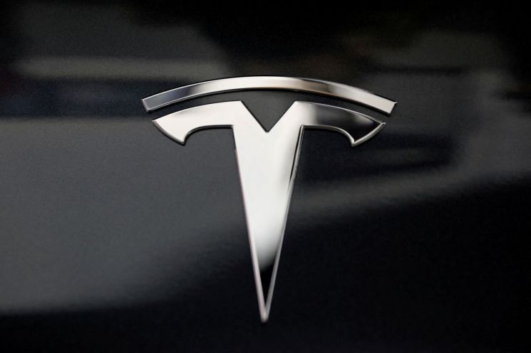 Tesla logo. Reuters Yonhap News