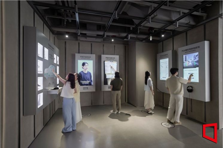 UX 스튜디오 상하이 내 UX 아카이브 존에 설치된 벽면 키오스크에서 방문객들이 콘텐츠를 탐색하고 있다. 현대차