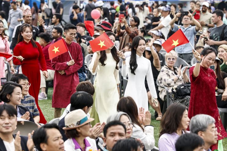 지난 13일 2026 화성특례시 세계문화축제에서 베트남 주민들이 국기를 흔들며 국가별 입장 퍼레이드에 참여하고 있다. 화성시 제공